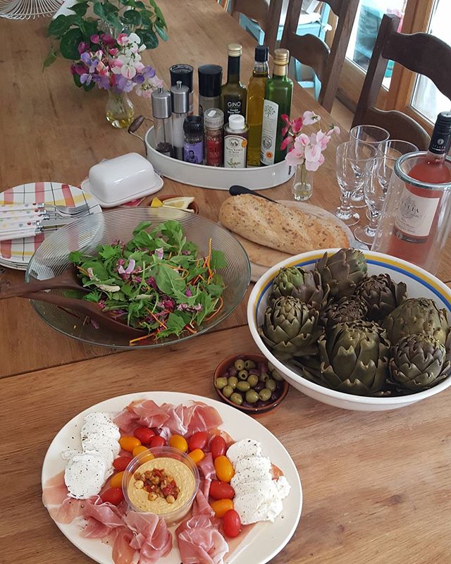Homegrown and healthy Summer lunch in the UK sun.

Lunch Italian-style by the pool.
Home grown artichokes, Isle of Wight tomatoes, humous,  salad with rocket, spinach, grated carrot and beetroot, mozzarella cheese, parma ham, olives and rose PInot Grigio wine and fresh bread.
Delicious!